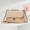 Elegant beige quilted leather flap bag with gold chain strap on minimalist display - Light Khaki