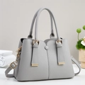 Grey pebbled leather handbag with gold hardware and adjustable strap for women - Gray
