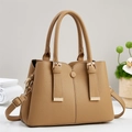 Detail of tan pebble leather handbag with gold hardware and removable shoulder strap - Khaki