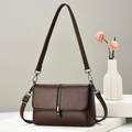 Deep coffee litchi grain leather shoulder bag with metallic buckle on white pedestal - Brown