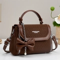 Elegant brown woven leather handbag with a large bow and pearl chain charm - Coffee