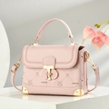 Pink crossbody phone bag with rabbit patterns and gold hardware on white pedestal - Pink