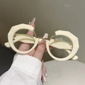 Close-up of irregular thick beige frames with gold metal accents on modern eyeglasses - Cream Gold Frame Clear Lens