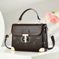 Dark brown messenger bag with owl print and gold hardware on white podium - Coffee