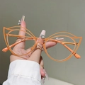 Detail of vibrant orange hollow cat-eye metal frames and stylish cutout glasses - Orange Frame Clear Lens