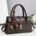 Detail of coffee brown leather tote with twill embossing, gold clasp, and silk scarf handle - 30x12x18cm / Coffee