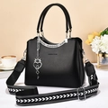 Black leather handbag with silver hardware and patterned wide strap, 2025 trendy style - Black