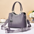 Chic purple leather handbag with wide arrow pattern shoulder strap and heart pendant - Purple