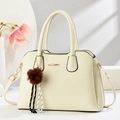 Detail of off-white lychee texture tote bag with plush ball charm and metal bar - White