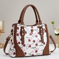White cherry print crossbody bag with brown trim and adjustable gold-tone metal strap - Off White