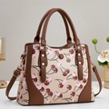 Beige crossbody bag with pink cherry prints and brown leather handles for women - Apricot