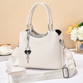 Creamy white leather tote bag with stylish wide geometric strap and metal heart charm - Off-white
