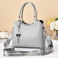Light gray leather handbag with geometric wide shoulder strap and heart pendant detail - Light Gray