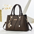 Fashionable dark brown tote bag with embossed letter texture and golden leaf pendant - Coffee