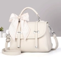 Detail of off-white leather handbag with lychee texture and plaid ribbon bow decoration - Off-white