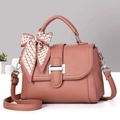 Detail of dusty pink leather tote with lychee texture and silk scarf handle decor - Dusky Pink