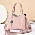 Pink crinkled leather handbag with heart lock charm and geometric shoulder strap - 25.5x20x11cm / Pink