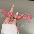 Close-up of translucent pink heart-shaped kids sunglasses with clear lenses - Gradient Pink Frame Gradient Pink Lens