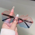 Nahaufnahme der apfelförmigen randlosen Kinder-Sonnenbrille mit pink-blauem Verlauf - Rosa-Blau Farbverlauf