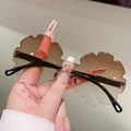 Detailed macro view of rimless petal shaped flower sunglasses with brown gradient lenses - Tawny Gradient