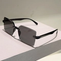 Close-up of black frameless square sunglasses with thin temples on a display block - Black