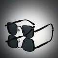 Detailed view of square black sunglasses with metal spring hinges and mirror reflection - Black Frame Grey Lens