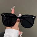 Detail view of black cat-eye sunglasses with signature silver metal accents on the frame - Lacquered Horizontal Bar & Dot Black Frame