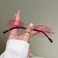 Detailed shot of rimless oval sunglasses with gradient pink lenses and metal temples - Gradient Pink