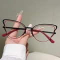 Detailed close-up of red and black cat-eye eyeglass frames with metal and acetate composite - Outer Black Inner Red (Transparent Lens)