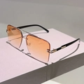 Close-up of semi-rimless square sunglasses with orange gradient lenses and gold bridge - Gold Frame Gradient Orange