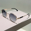 Nahaufnahme der runden Retro-Sonnenbrille aus Goldmetall mit grauen Verlaufsgläsern - Goldener Rahmen Graue Verlaufsgläser