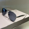 Detail of silver aviator sunglasses with polarized lenses on a textured display stand - Silver Frame Black Grey Lens