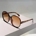 Round leopard print oversized sunglasses with brown gradient lenses on geometric stand - Leopard Frame Gradient Tea Lens
