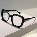 Detail of cat-eye frames featuring silver feather-shaped metal accents on temple hinges - Black Frame Clear Lens