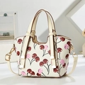 Detailed macro of cherry print handbag with golden hardware and adjustable strap - Off-white