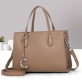 Close-up of brown leather tote with pebble texture and metallic C pendant charm - Dark Khaki