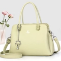 Elegant light green pebble leather handbag with top handles and cat charm detail - Green