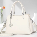 Detail of white lychee textured crossbody bag with silver logo and floral chain charm - Off-white