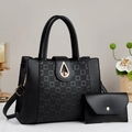 Detail of black pebbled leather tote set with gold hardware and envelope clutch - Black