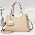 Beige litchi grain leather handbag with silver hardware and mini decorative charm - Light Khaki
