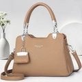 Detail of brown litchi pattern leather handbag with silver hardware and charm - Dark Khaki