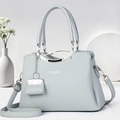 Detailed macro shot of lychee grain leather texture and elegant silver handle on a tote bag - Blue