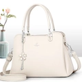 Detail of David Jones Paris beige tote bag with litchi texture and floral tassel charm - Off-white