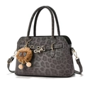 Detail of grey leopard print handbag featuring a plush lion charm and metal buckle - Gray