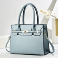 Light blue lychee grain leather handbag with gold twist lock and crossbody strap - Blue