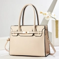 Detailed view of beige textured leather handbag with gold twist lock and shoulder strap - Off White