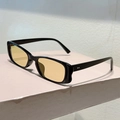 Detail of vintage rectangular sunglasses with yellow lenses and silver rivet accents - Black Frame Light Tea Lens