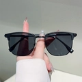 Detailed view of hand-held vintage retro square semi-rimless sunglasses with dark lenses - Black Frame Grey Lens
