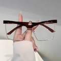 Occhiali cat-eye con arcata in acetato marrone e montatura in metallo oro chiaro - Tè Trasparente