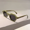 Close-up of olive green hexagonal sunglasses frame featuring silver rivet detail - Green Frame Grey Lens